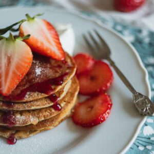 Plate of strawberry pancakes with syrup